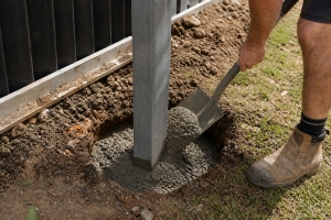 person using rapid set concrete  for a fence post